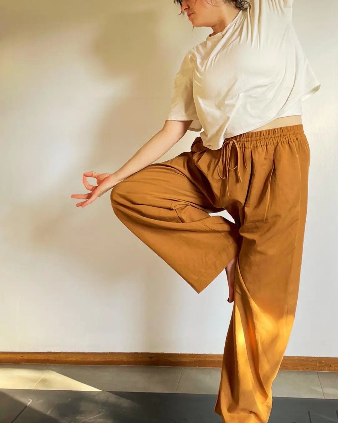 A woman balancing mindfully on one leg during yoga