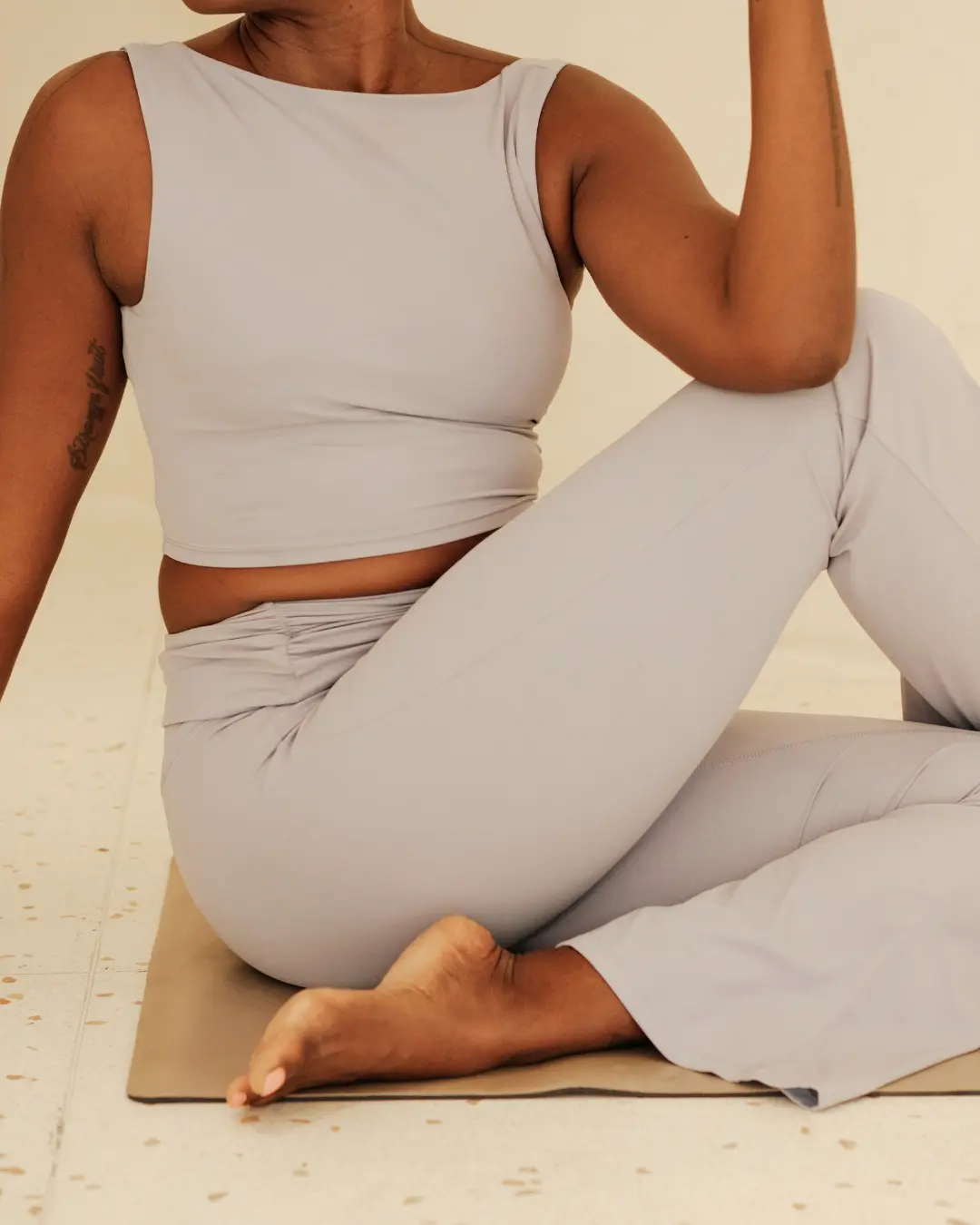A yoga practitioner seated comfortably on a mat